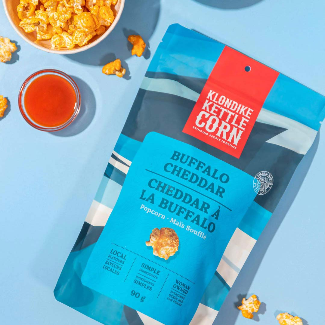 Klondike Kettle Corn package next to bowls of kettle corn and sauce.