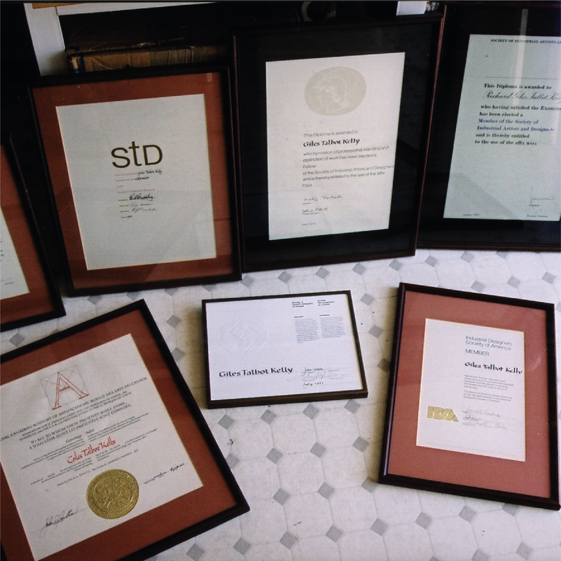 Photo of some of the many awards and accolades received by Giles Talbot Kelly.